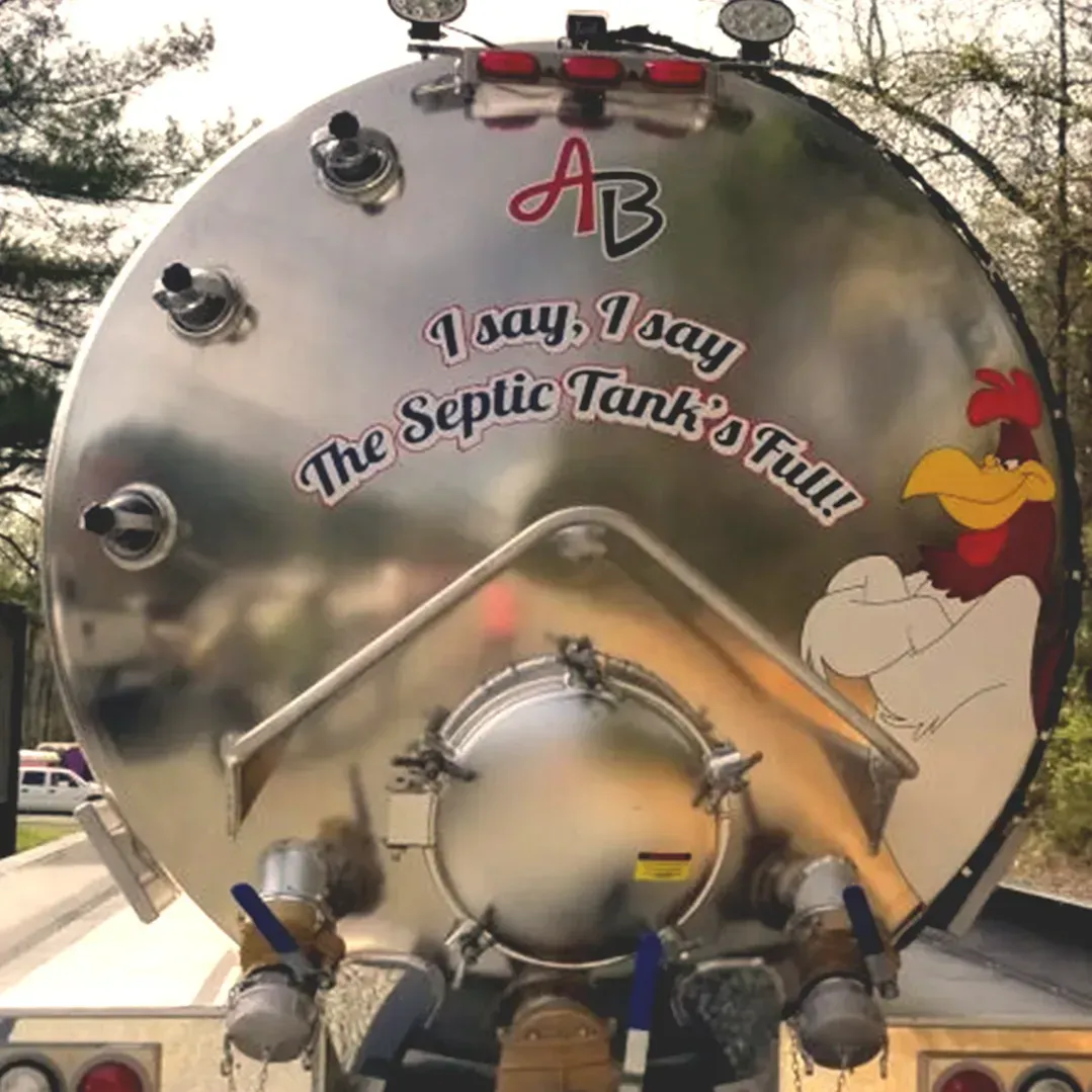 Rear view of a silver septic tanker truck featuring Foghorn Leghorn with the text, 