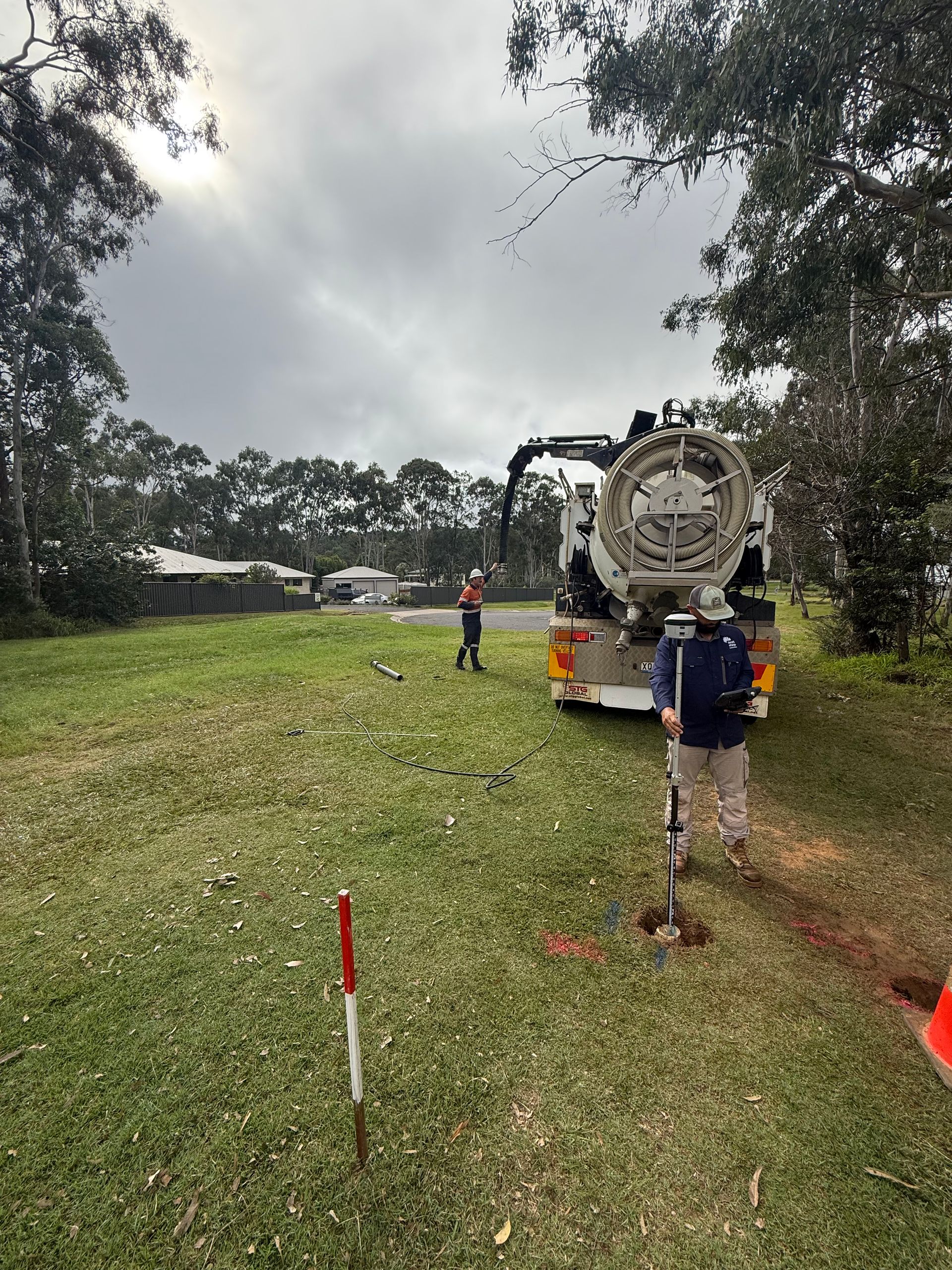 Workers With Truck on Grassy Area — Next Step Surveying in Redcliffe, QLD