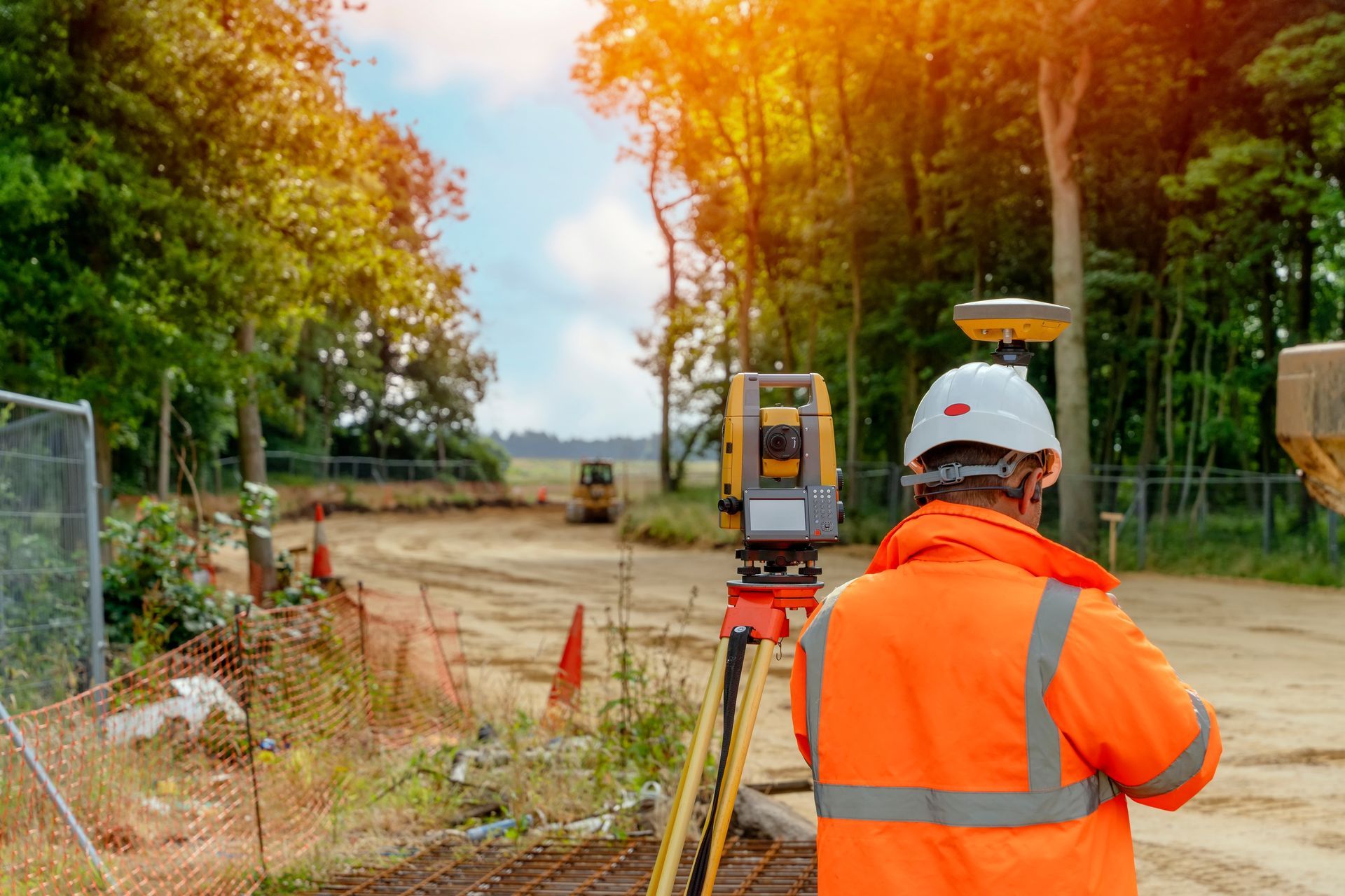 Construction Worker in Orange Vest Uses Surveying Equipment — Next Step Surveying in Kawana, QLD