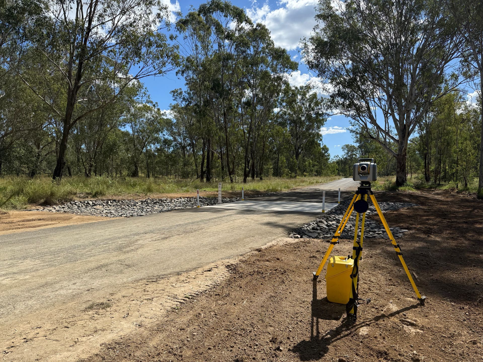 Surveying Tripod With Equipment on a Dirt Road — Next Step Surveying in Caboolture, QLD