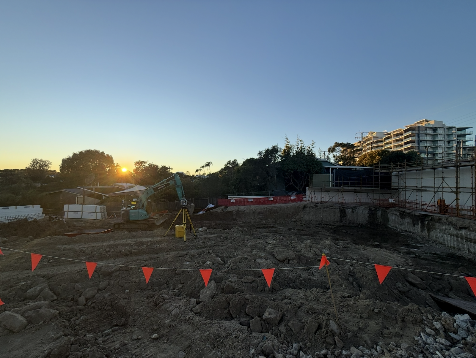 Construction Site at Sunset With Equipment — Next Step Surveying in Redcliffe, QLD