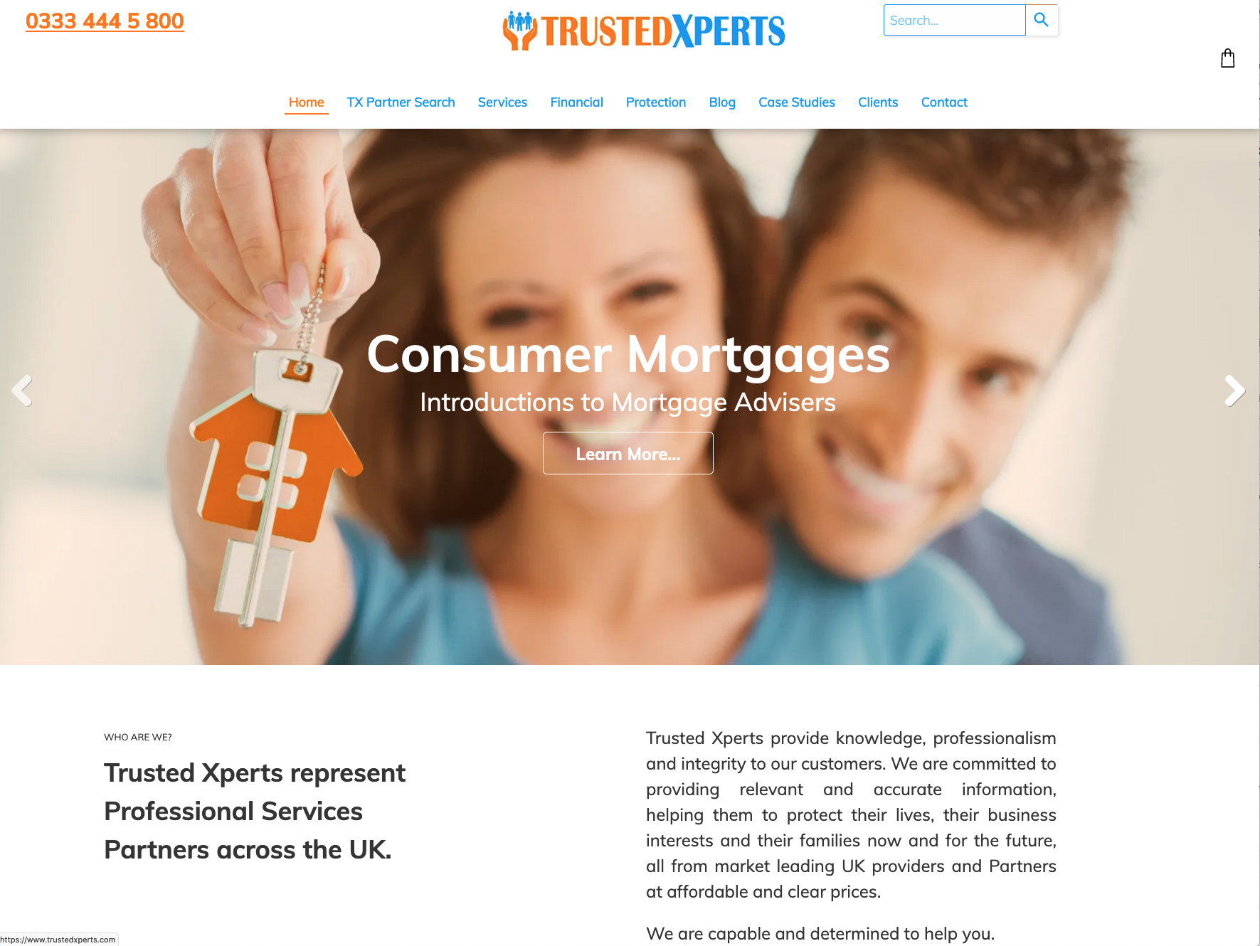 A man and a woman are holding keys in front of a website that says consumer mortgages