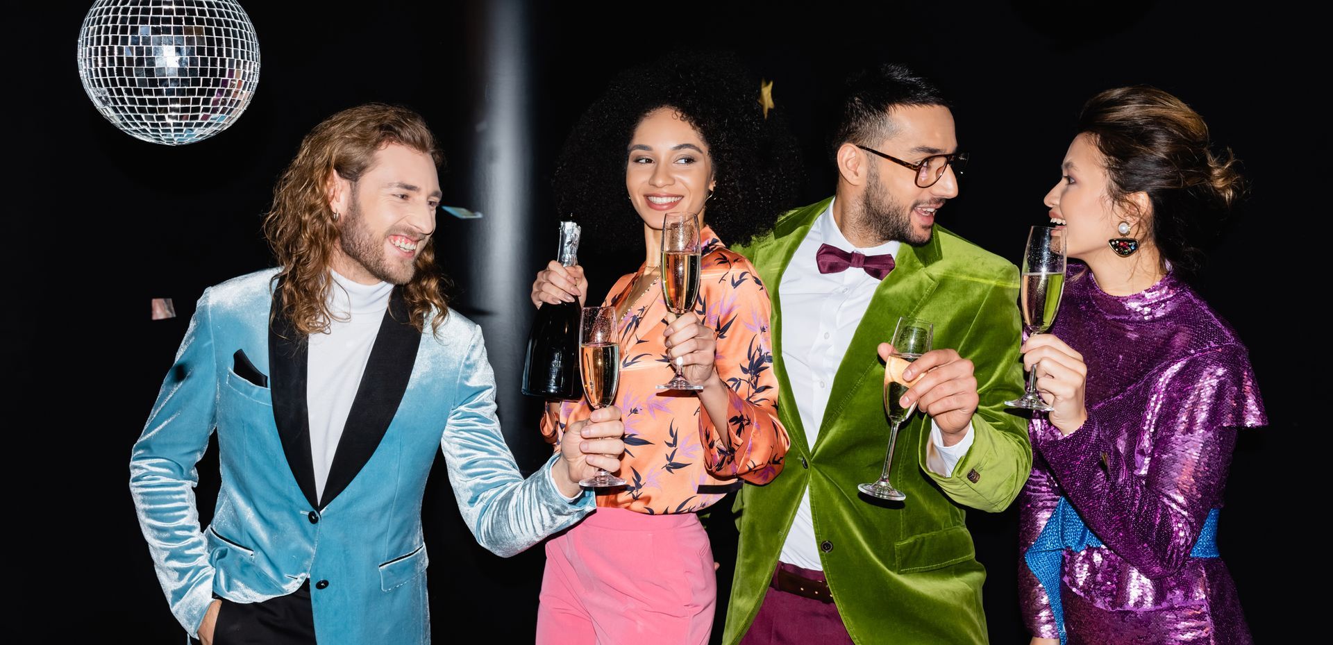 GROUP OF PEOPLE IN NIGHTCLUB WHERE THEY ARE MEMBERS a group of people toasting with champagne in front of a disco ball in their favourite nightclub where they are members