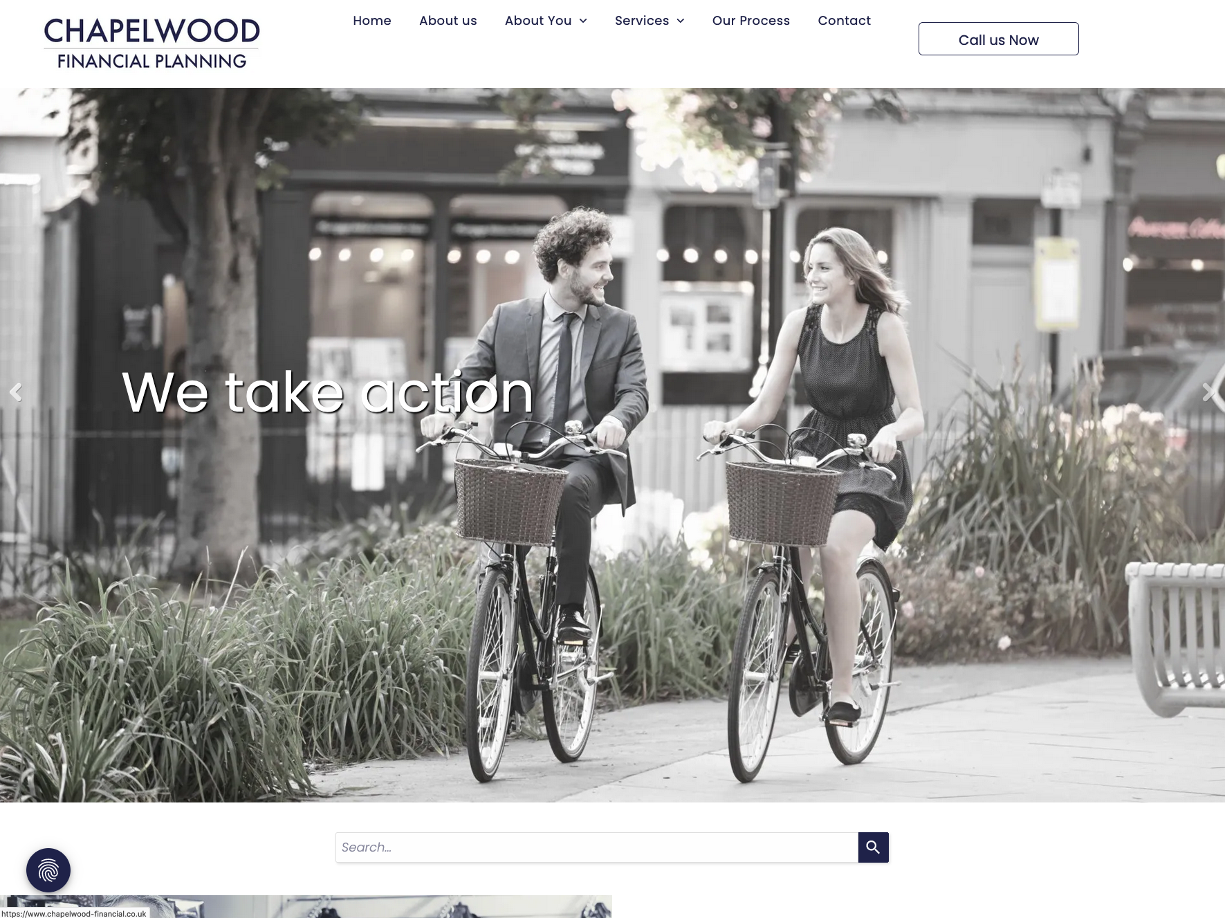 A man and a woman are riding bicycles down a street.