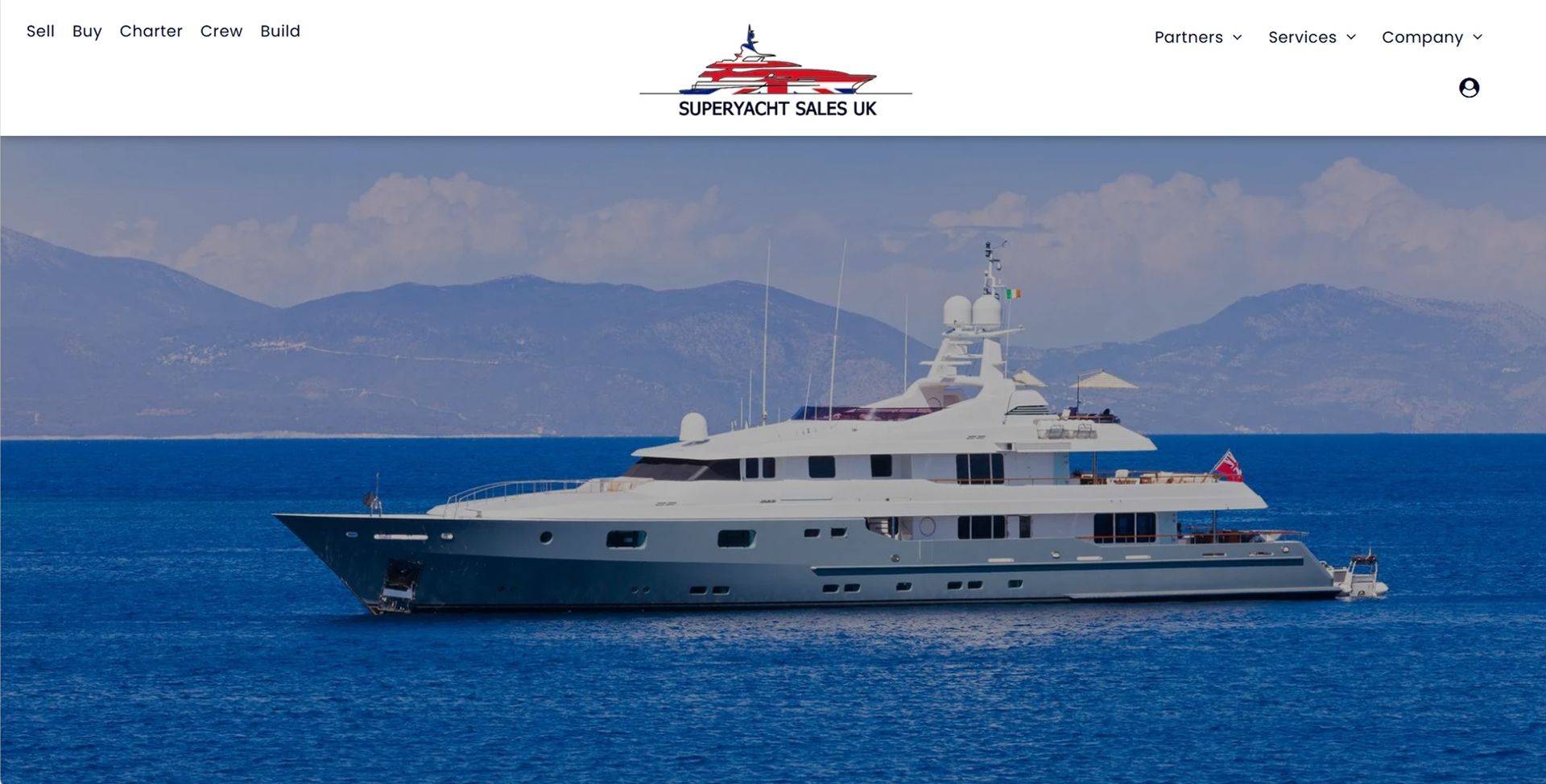 A large white yacht is floating on top of a body of water