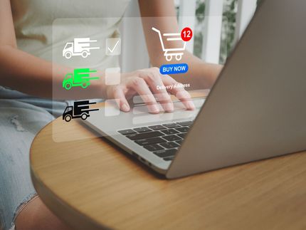 Woman using laptop, online shopping with delivery options overlaid on screen.