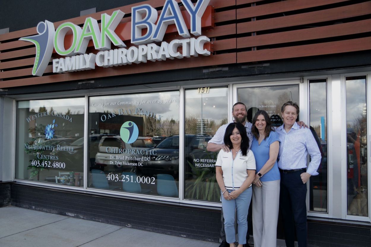 A group of people standing in front of a chiropractic office.