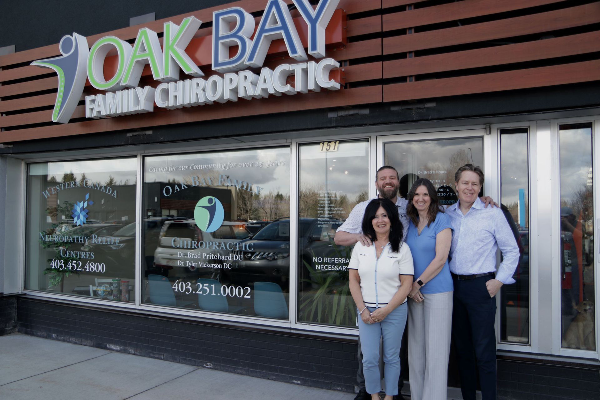 A group of people standing in front of a chiropractic office.