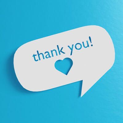 A thank you speech bubble with a heart cut out of it on a blue background.