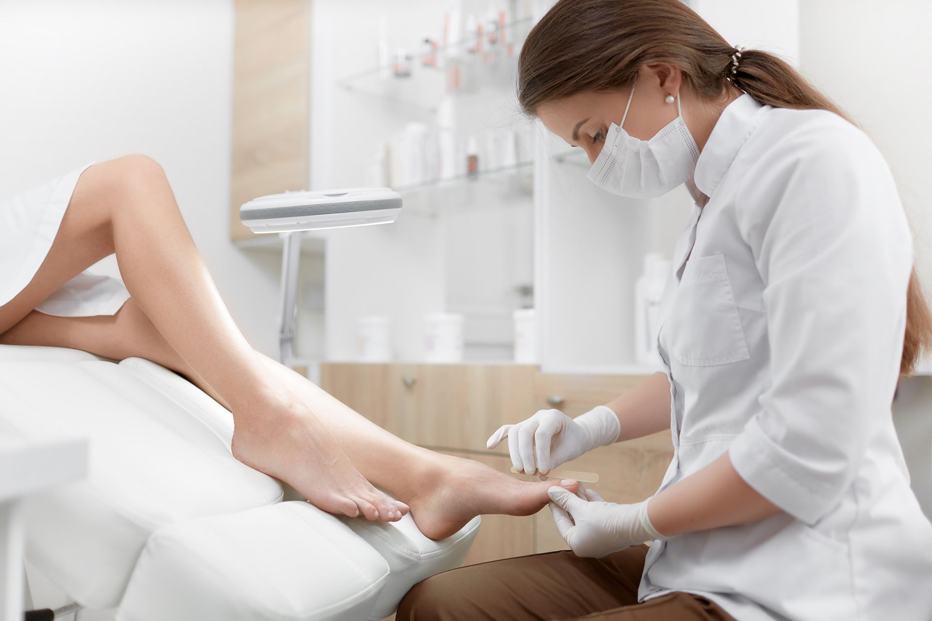 A podiatrist is treating a patient’s feet.