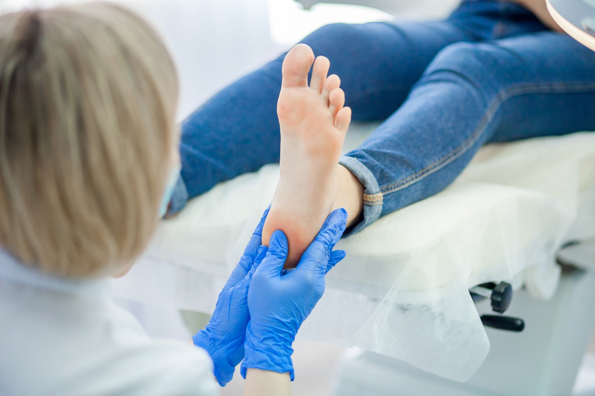 A podiatrist is checking a patient’s foot. A podiatrist is checking a patient’s foot.
