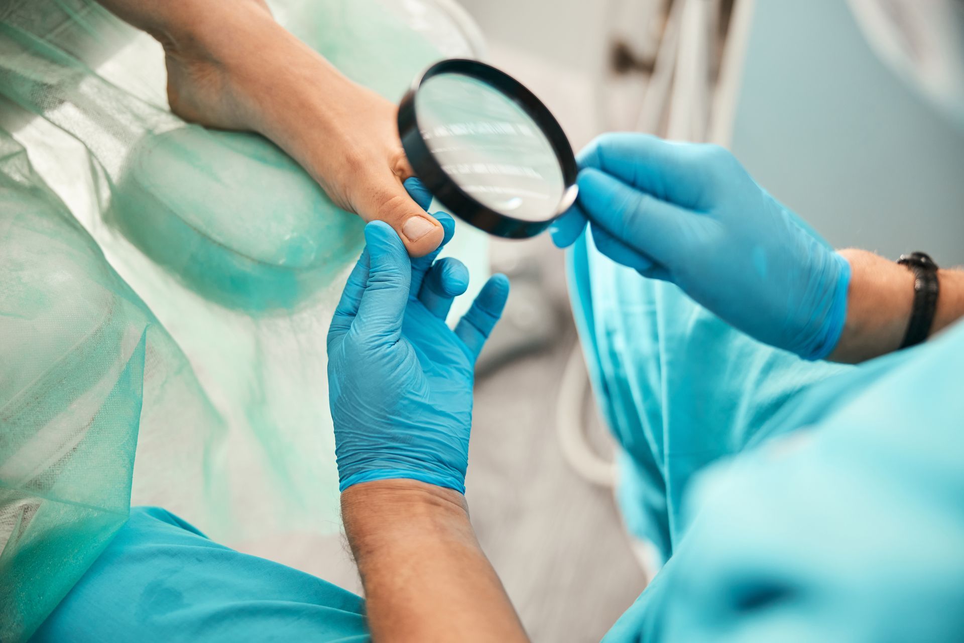A podiatrist is checking a patient’s toenail. A podiatrist is checking a patient’s toenail.