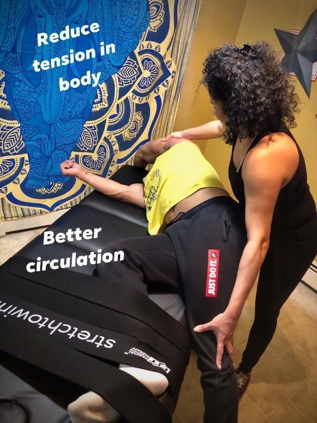 Person receiving a massage on a black table, with text reading “Reduce tension in body” and “Better circulation”