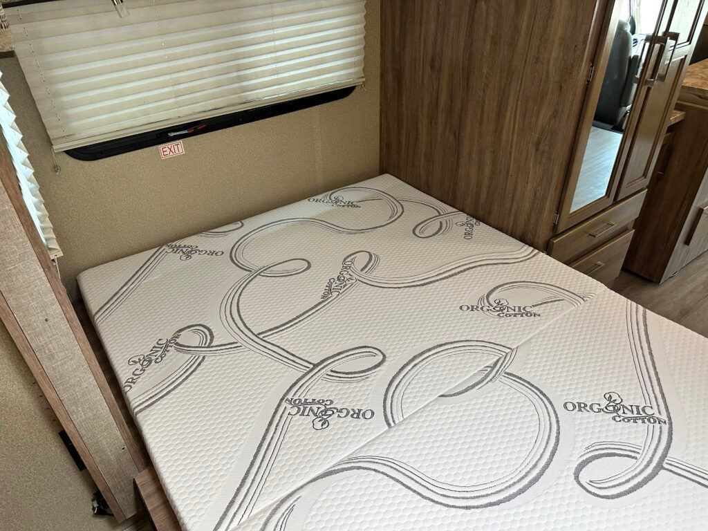 A mattress is sitting on top of a bed in a rv.