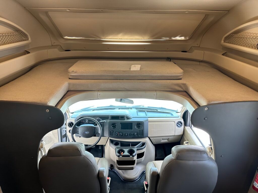 The inside of a rv with a bed in the back