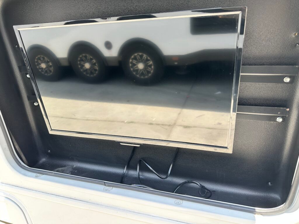 A tv is mounted in the back of a vehicle
