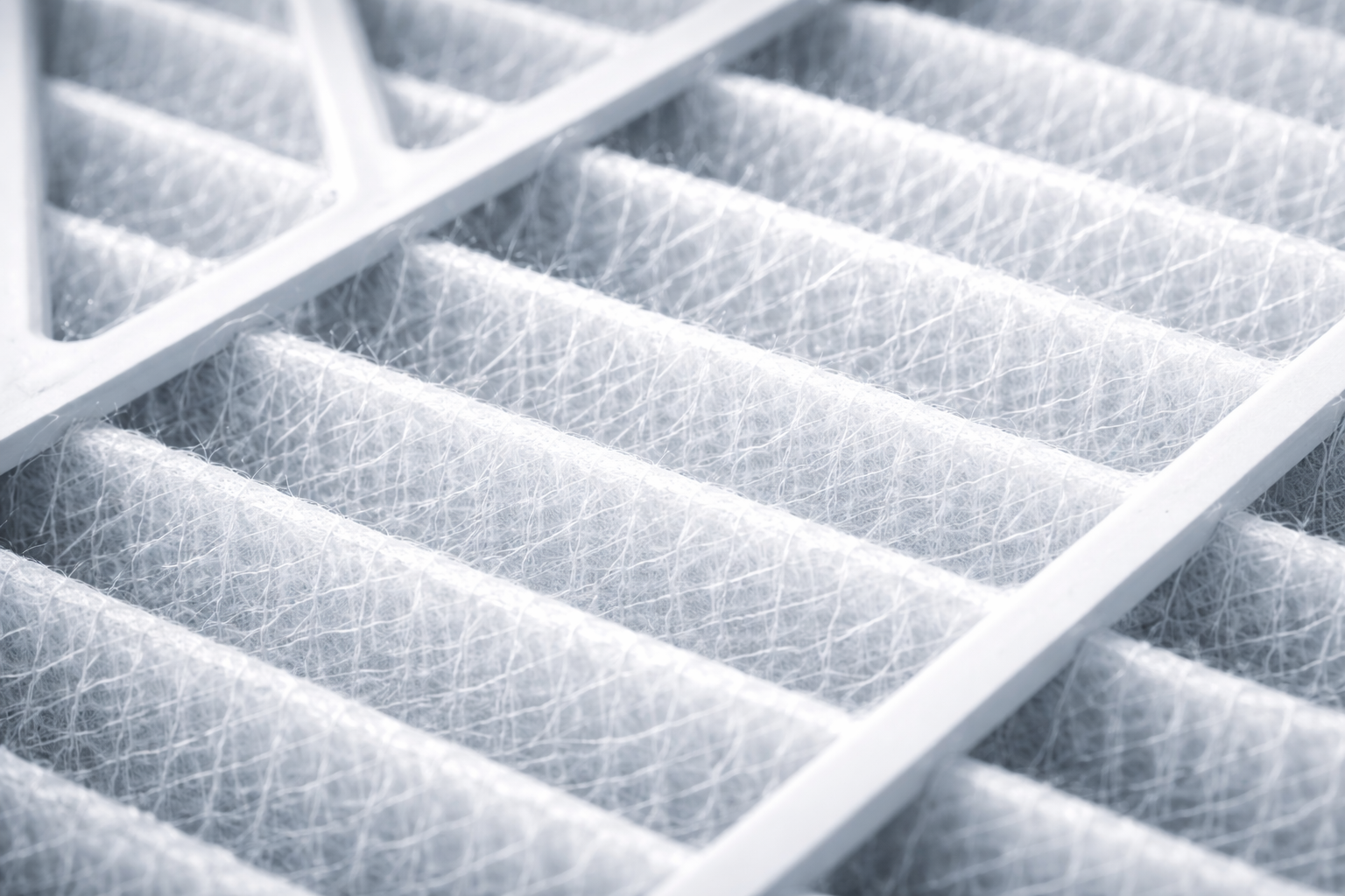 Close-up view of a clean, pleated white air filter with a supportive frame.
