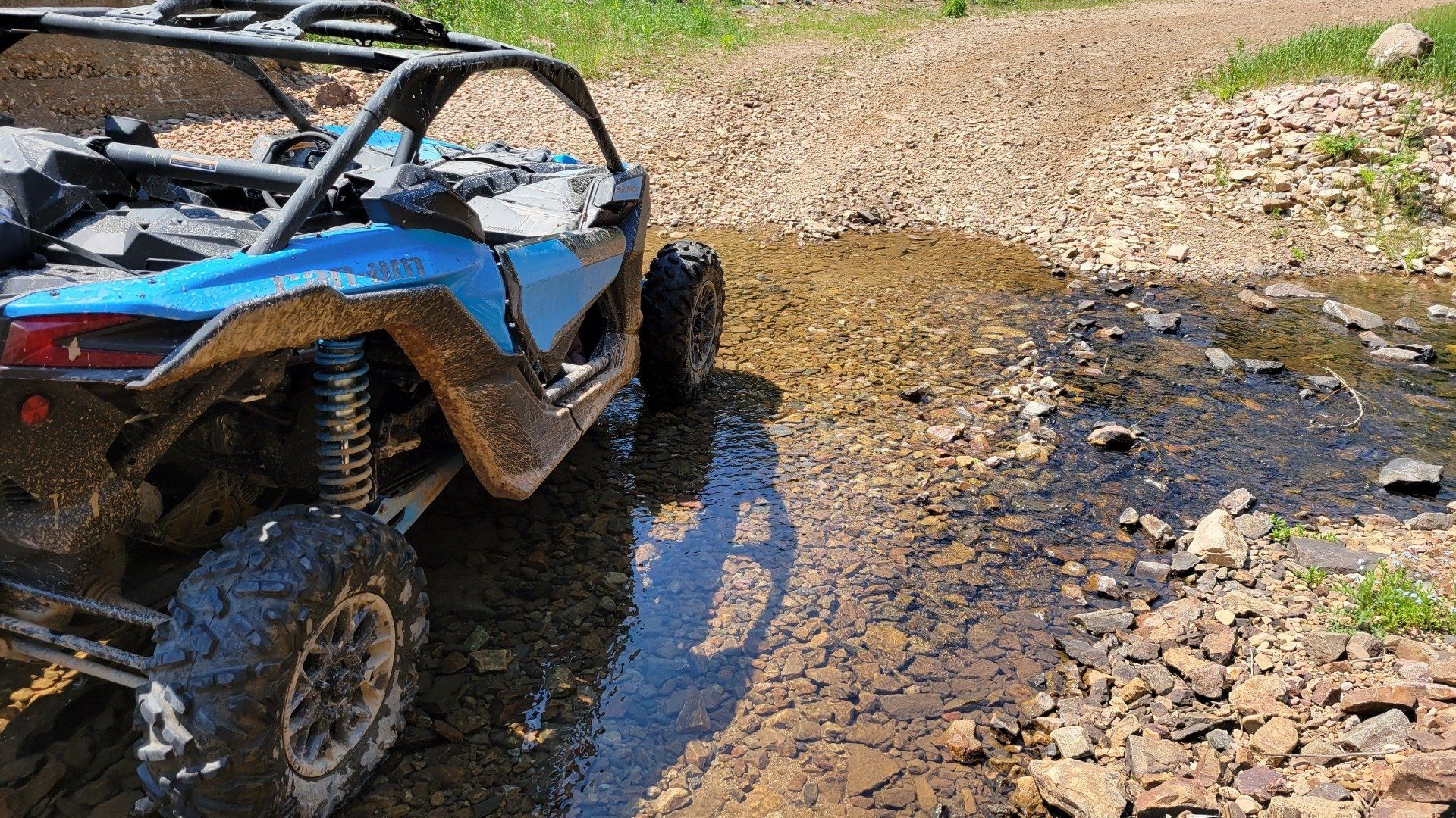 Two UTVs crossing a field