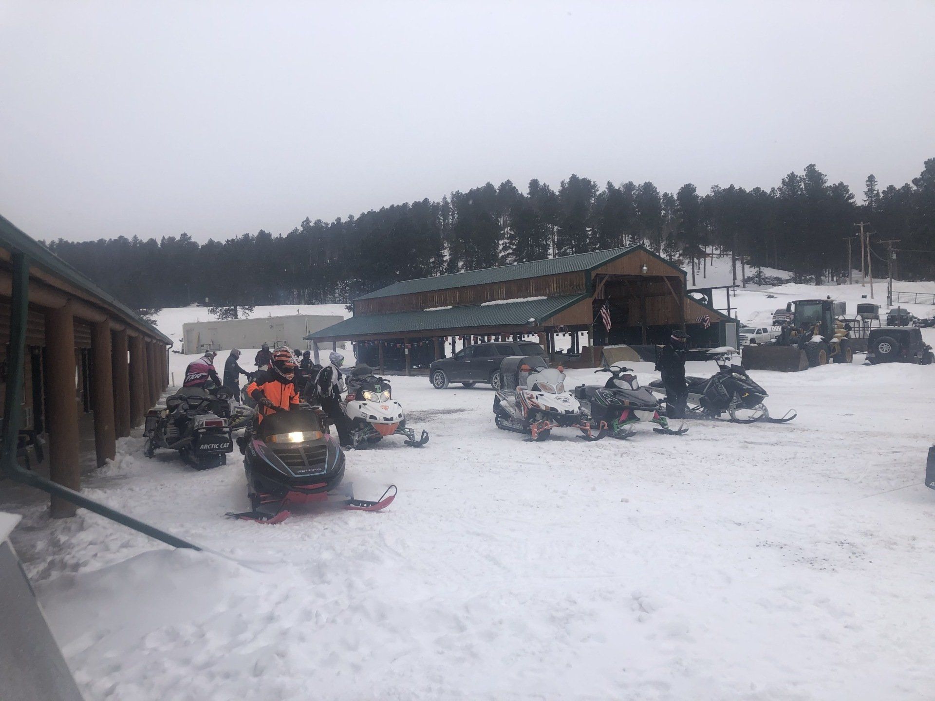 Rider with yellow helmet on a yellow snowmobile