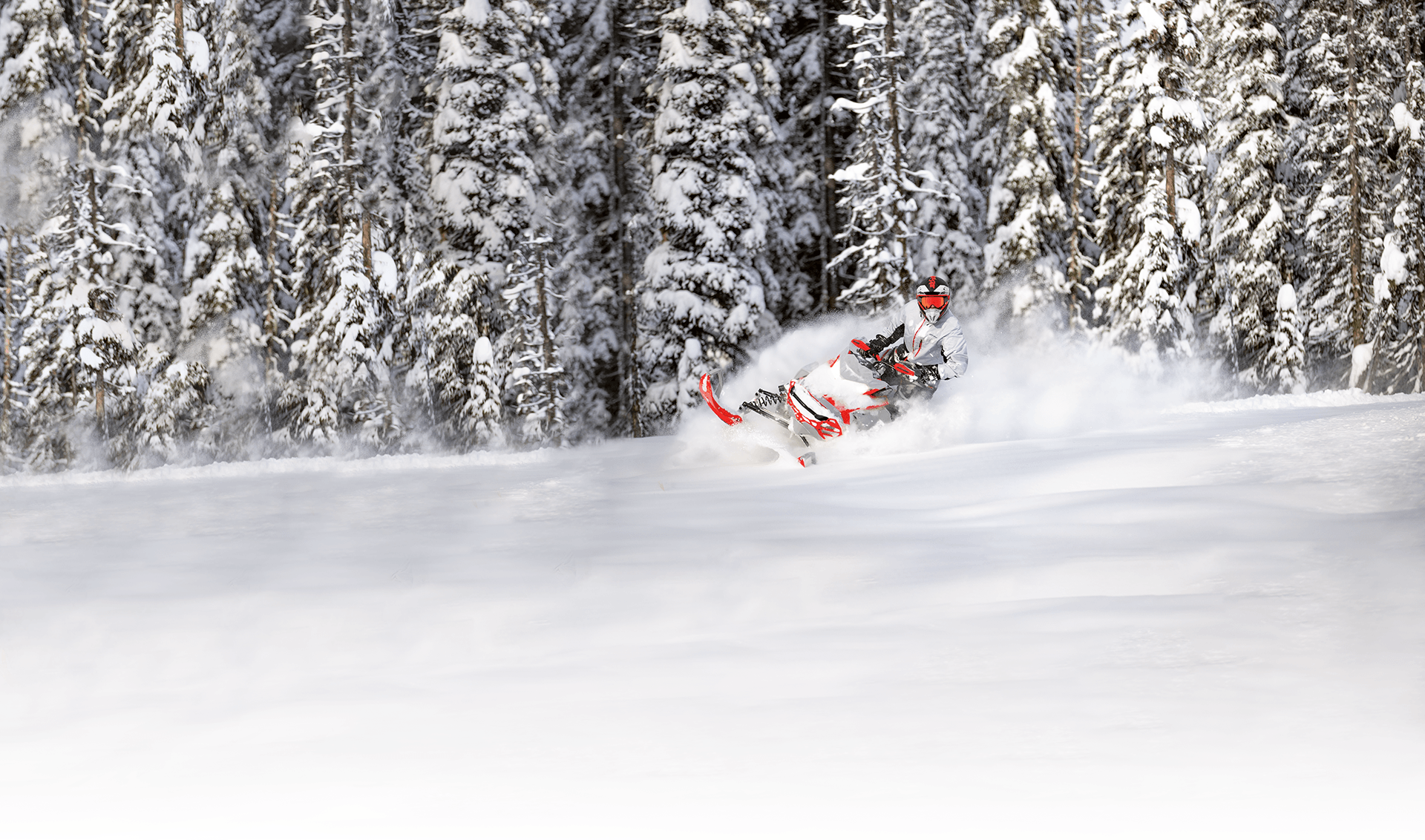 Man on a matching suit color riding a snowmobile