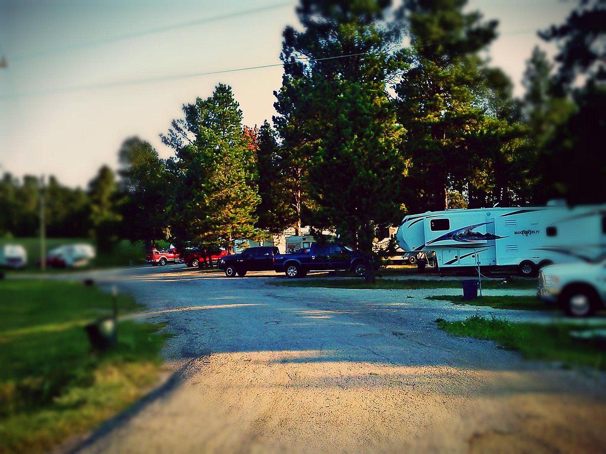Cars and RVs parked beside the road