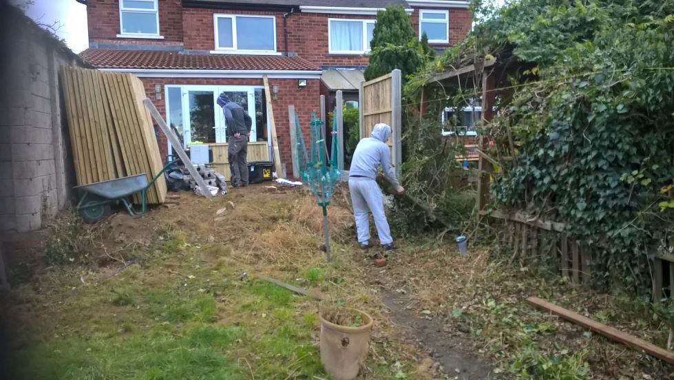 Scruffy back garden with new patio planters and fencing by buildjunky.com
