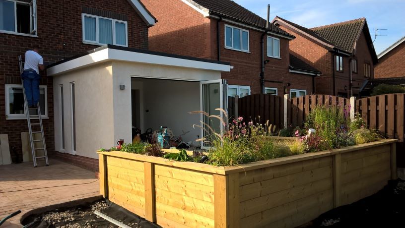 outdoor timber planter with lights at night sitting and patio area by buildjunky.com