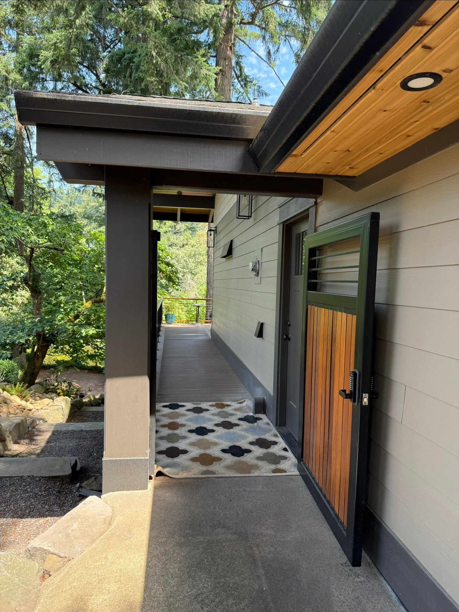 Covered walkway entrance with tile flooring at Dearey Residence in Washougal, WA