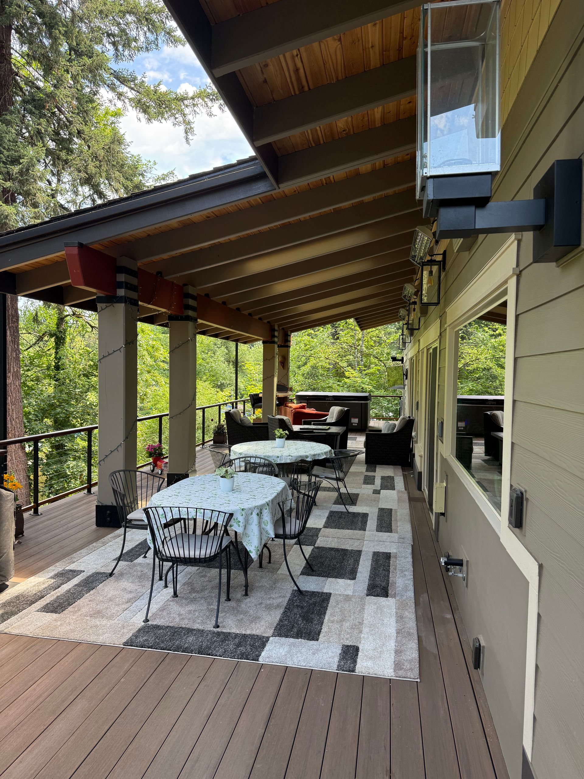 Covered patio dining area with tile flooring built by Elite Construction & Design at Dearey Residence in Washougal, WA