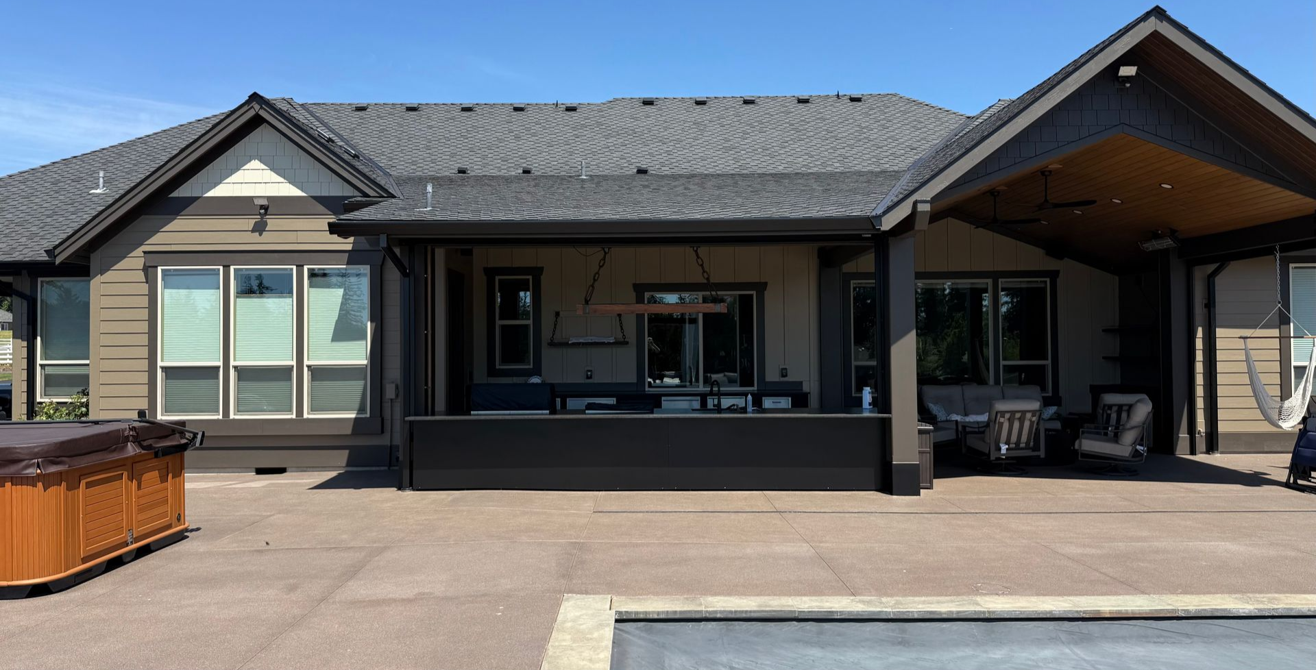 Covered poolside outdoor kitchen and bar at a luxury custom home in Washougal, WA