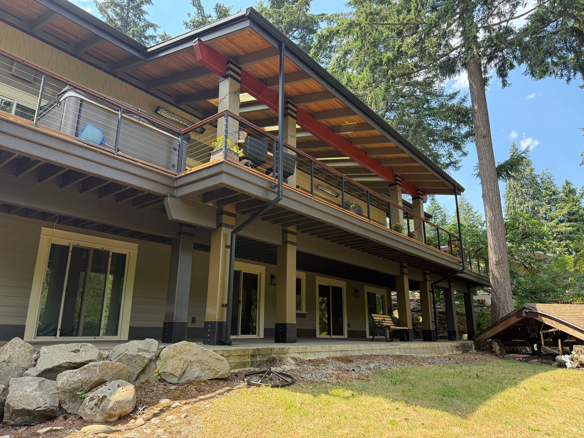 Dearey Residence contemporary custom home exterior with wraparound deck and cedar accents in Washougal, WA