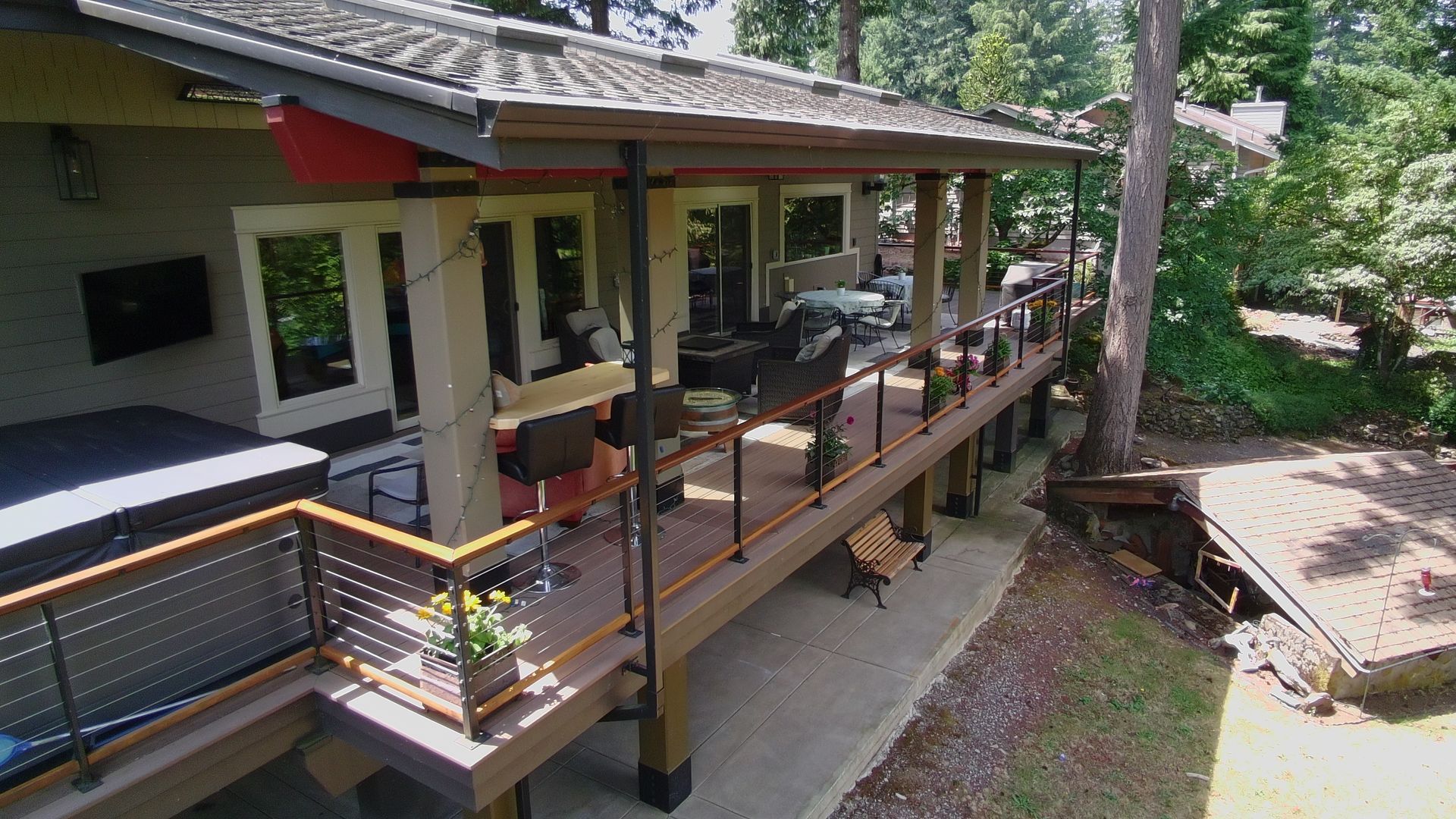 Wraparound covered deck with cable railing at Dearey Residence in Washougal, WA