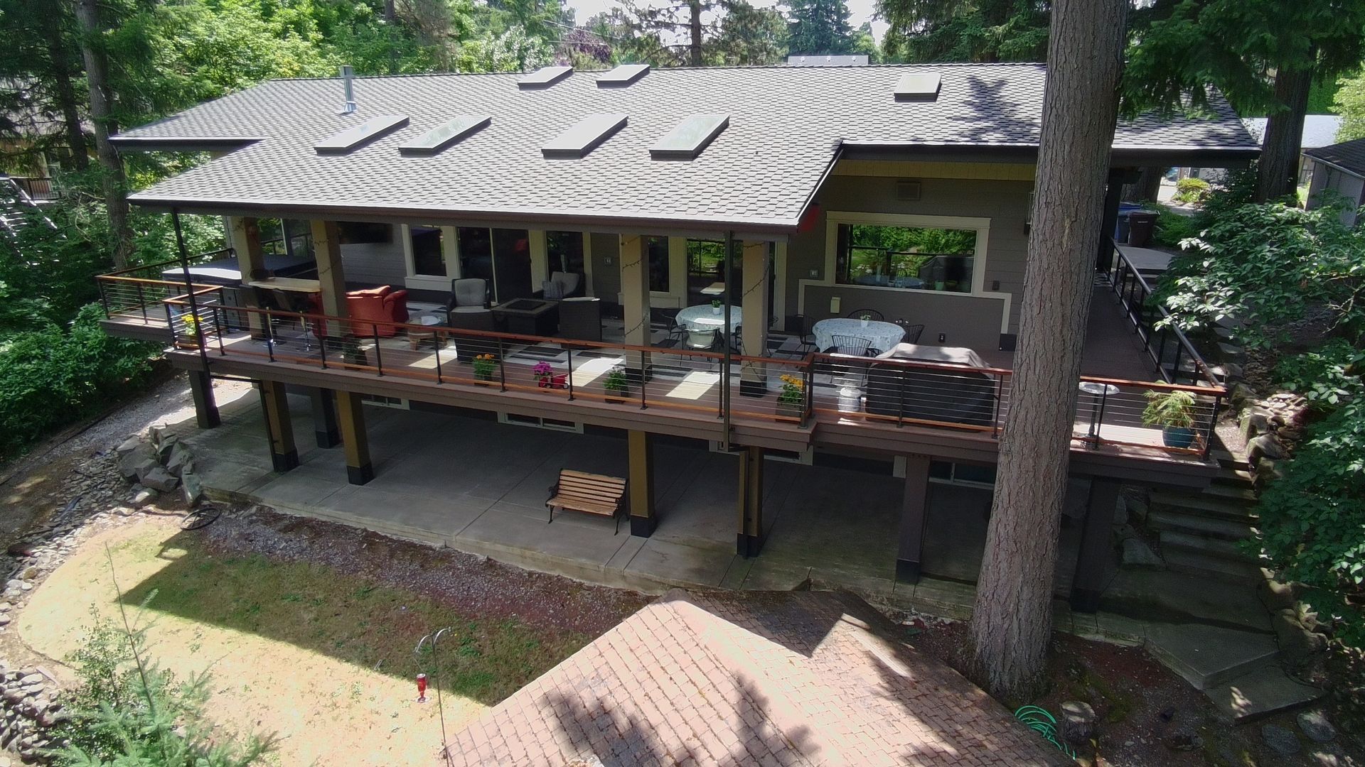 Aerial view of Dearey Residence roofline and covered deck surrounded by trees in Washougal, WA