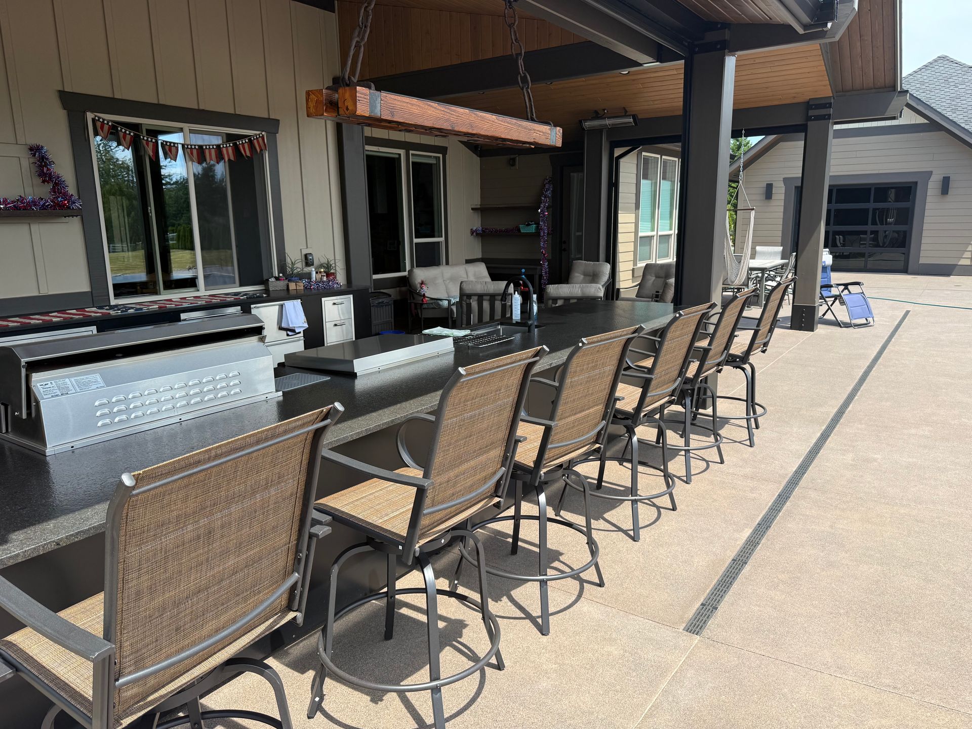 Covered outdoor patio bar with seating for entertaining at custom home in Washougal, WA