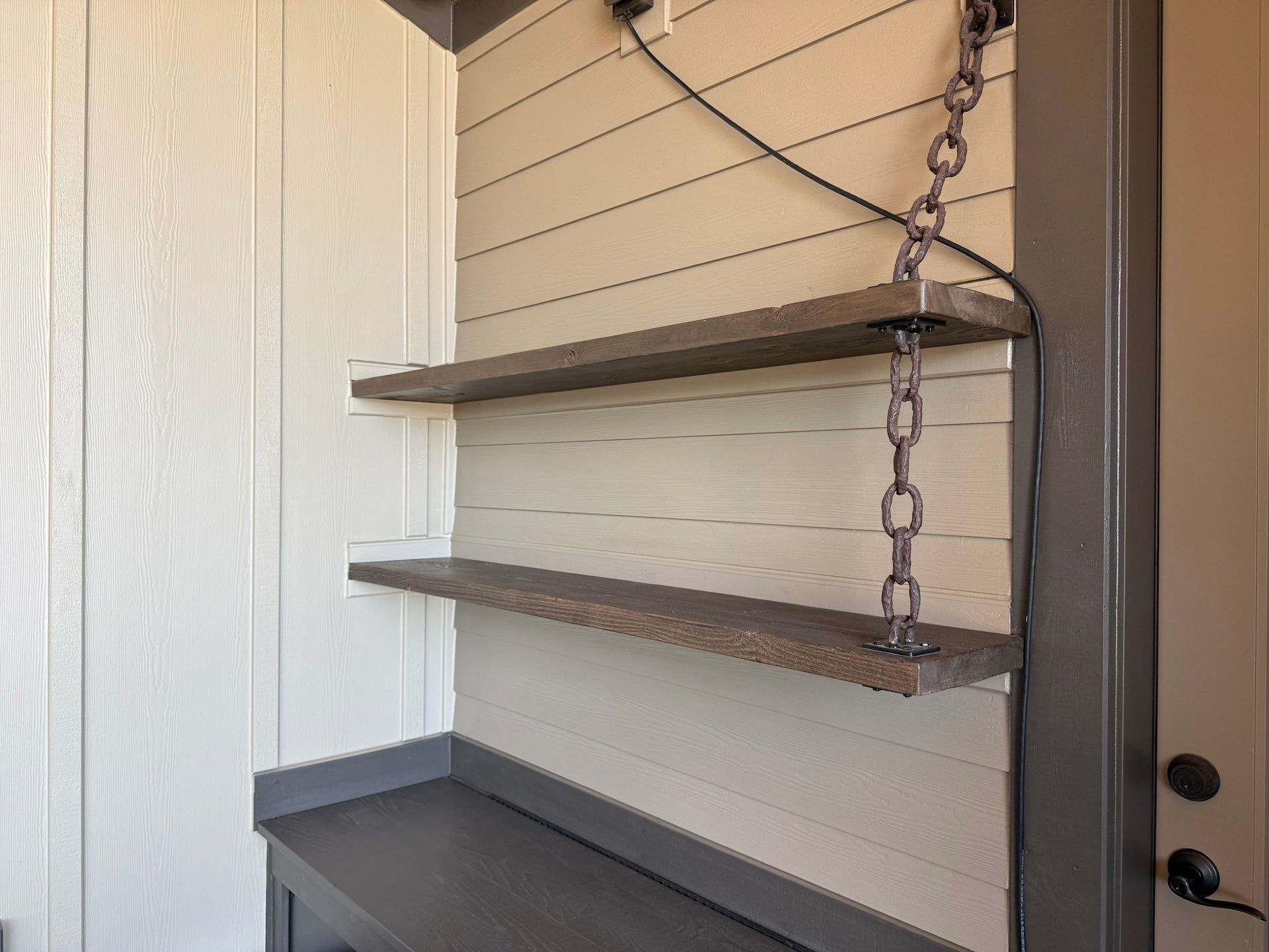Custom wood hanging shelves with rustic chain supports at a Washougal, WA home