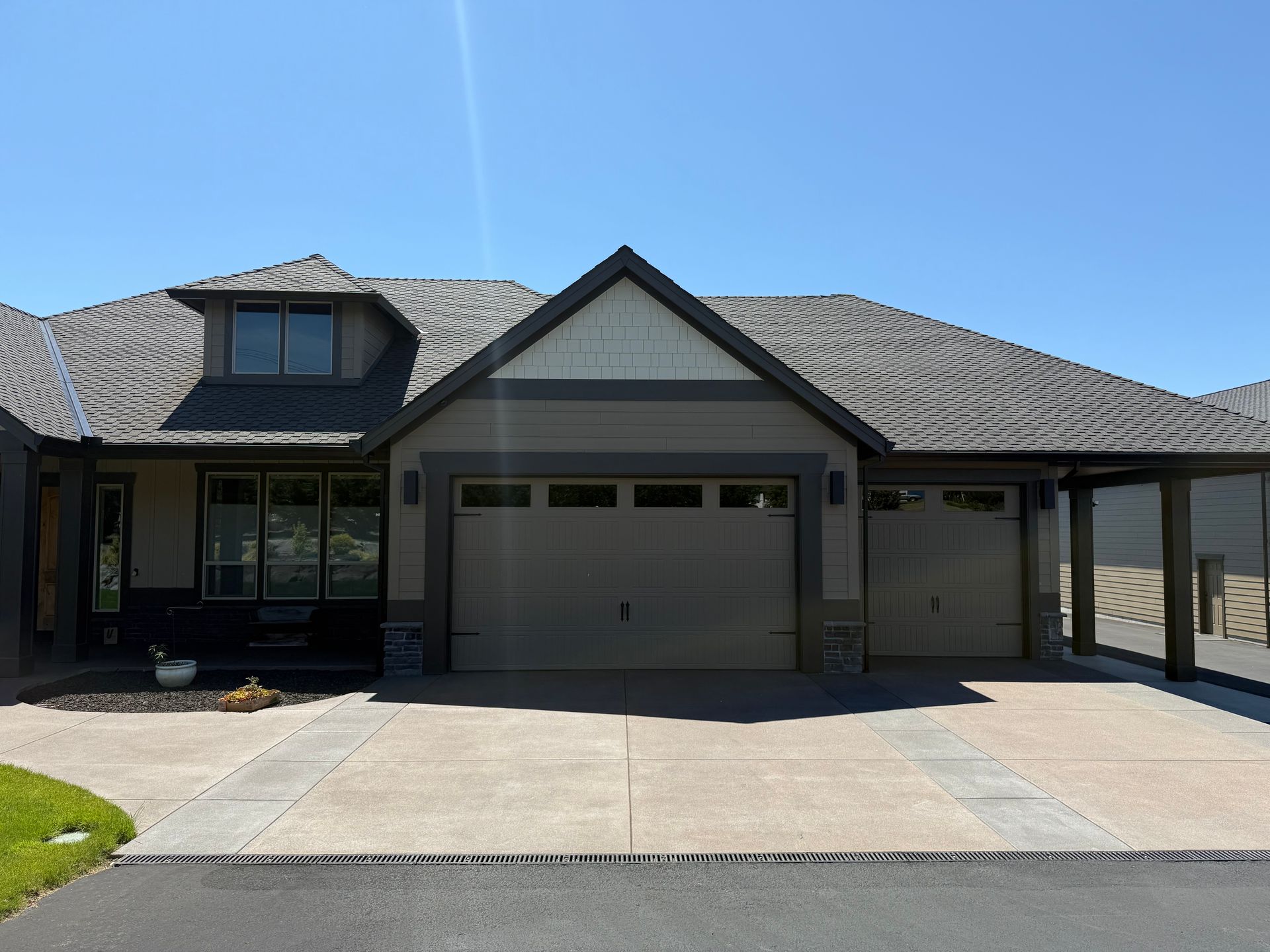 Three-car garage with modern Pacific Northwest exterior design