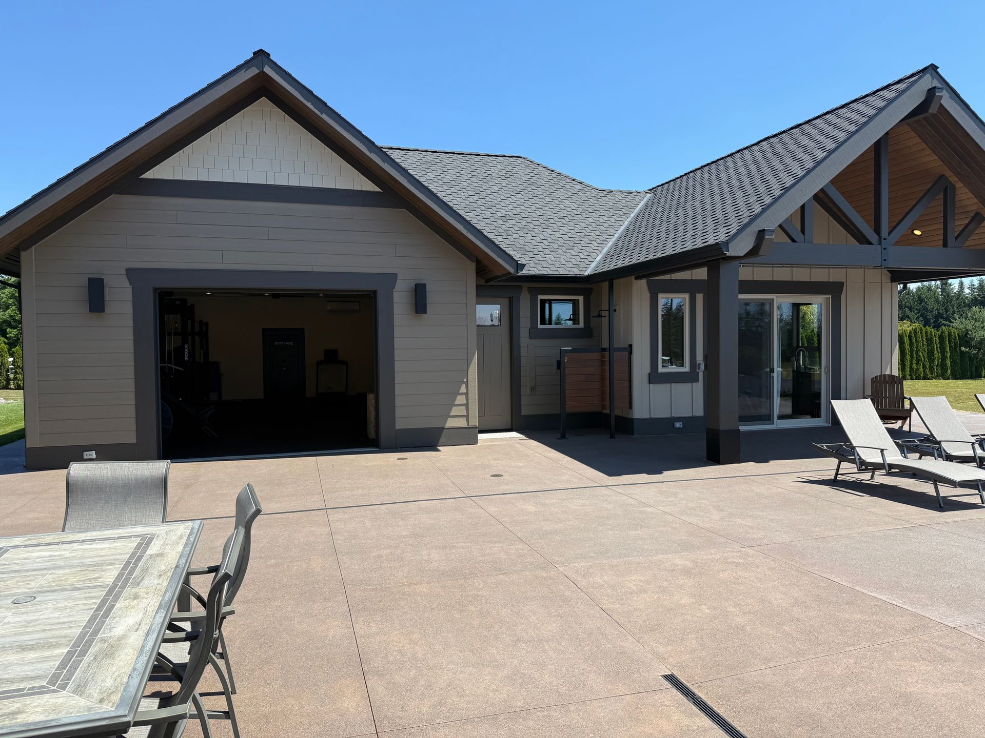 Custom pool house exterior with an attached garage and covered patio in Washougal, WA