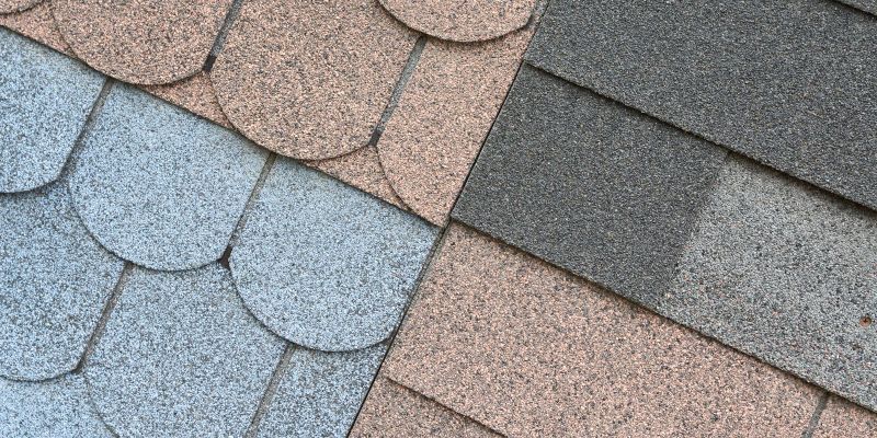 Close-up of asphalt roof shingles in shades of gray, brown, and blue.
