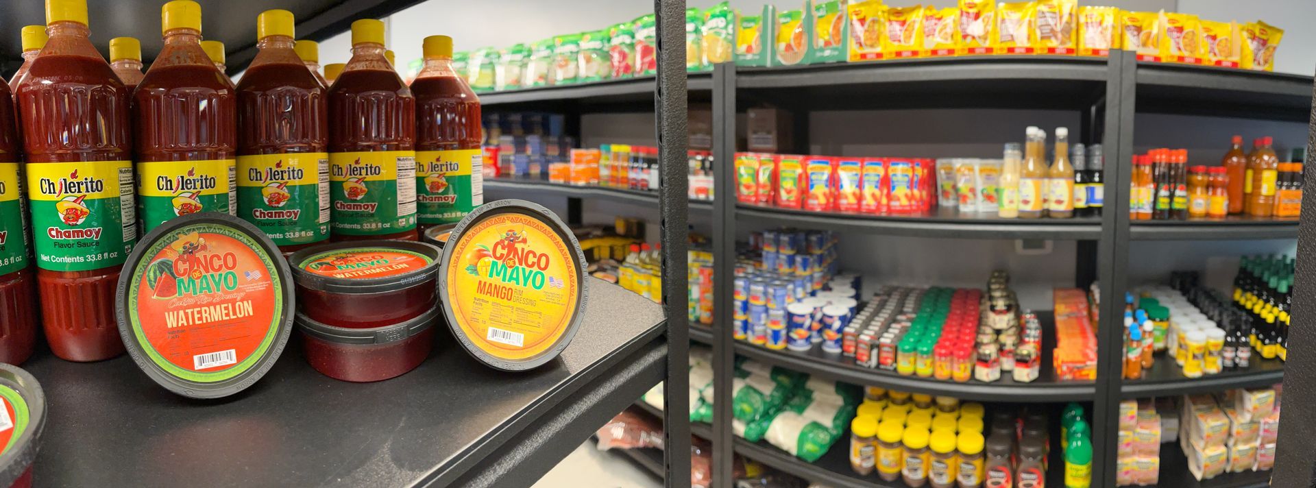 A grocery store shelf filled with lots of food and drinks.