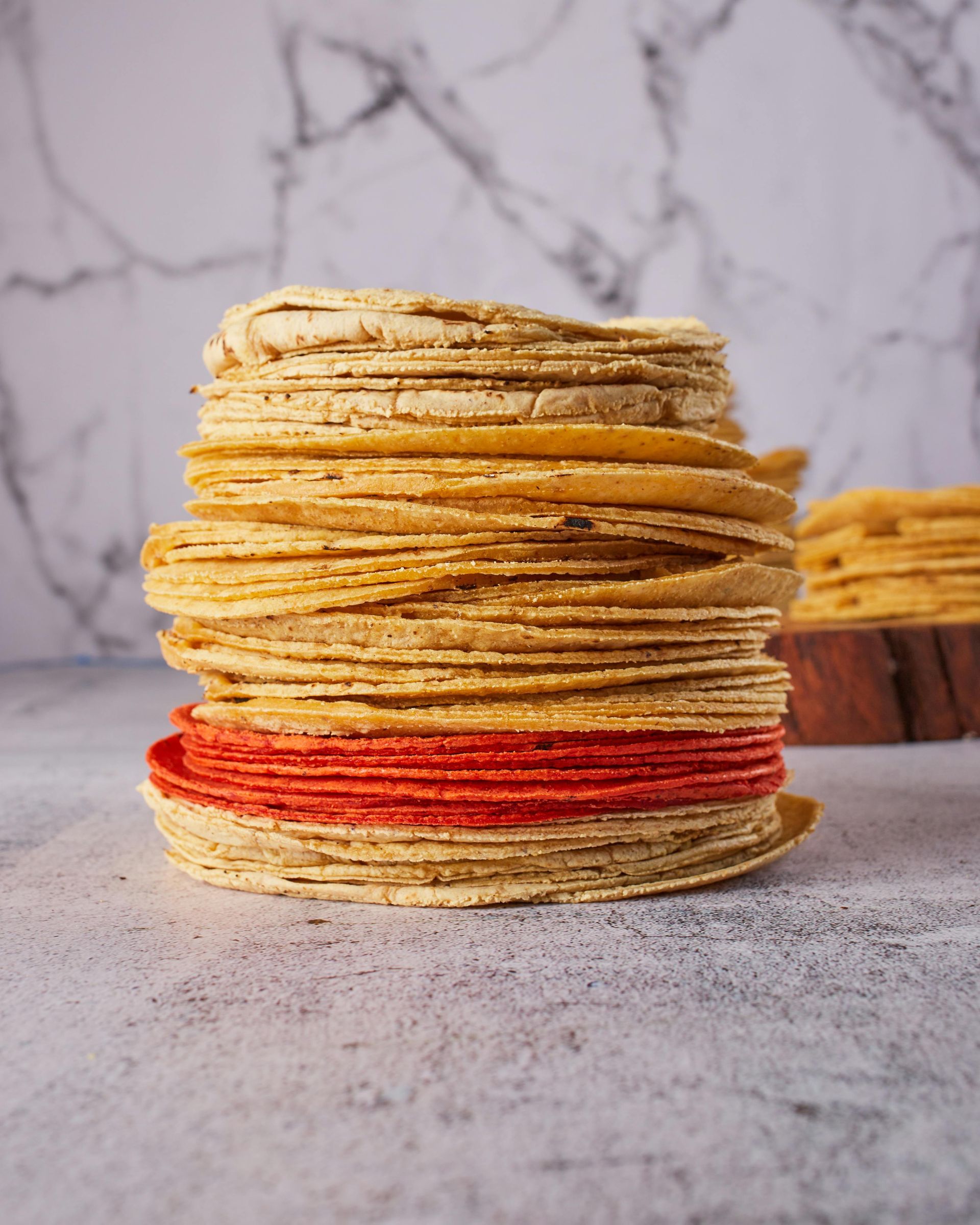 A close up of a stack of tortillas on a table.