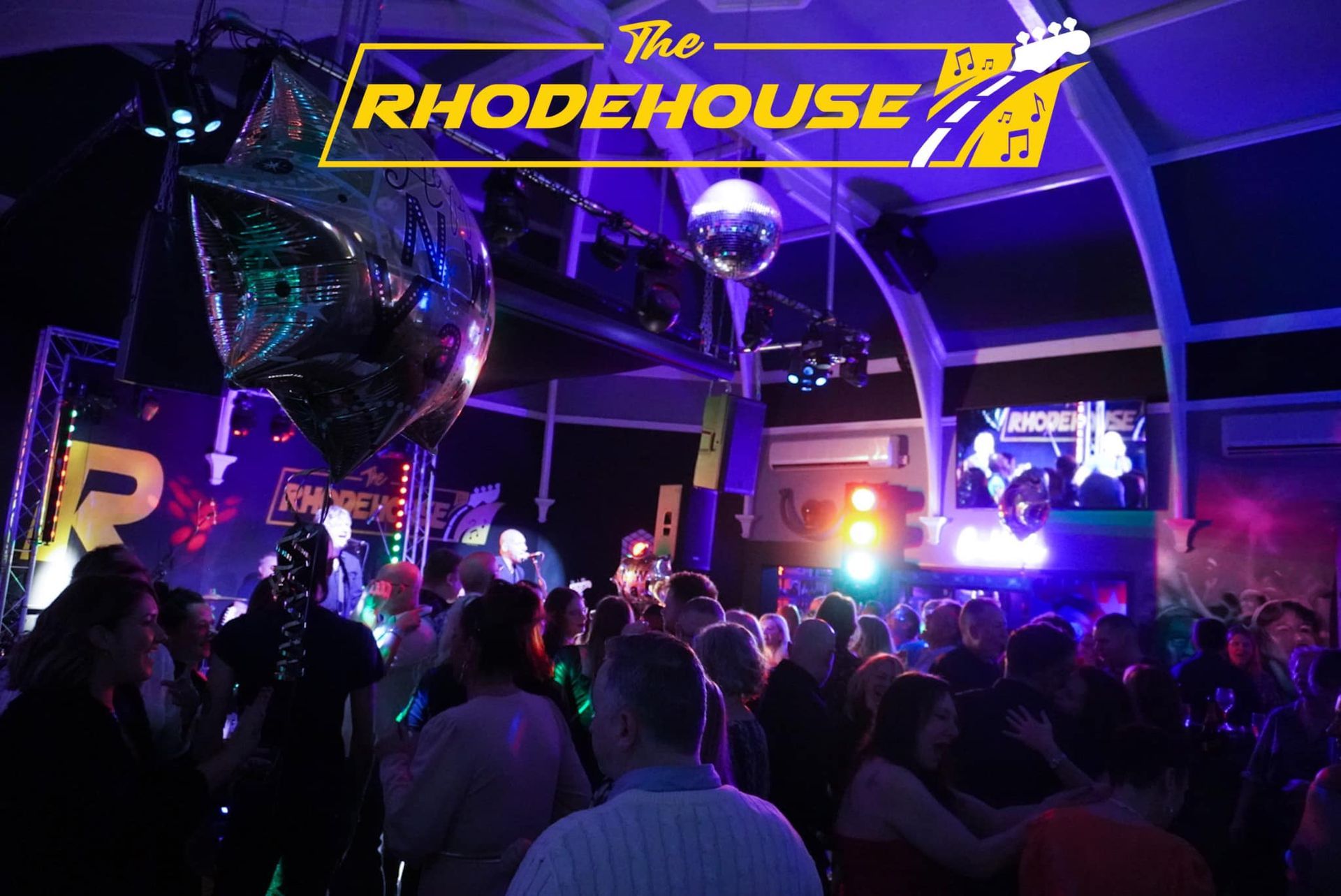 A crowd of people are dancing at the rhodehouse