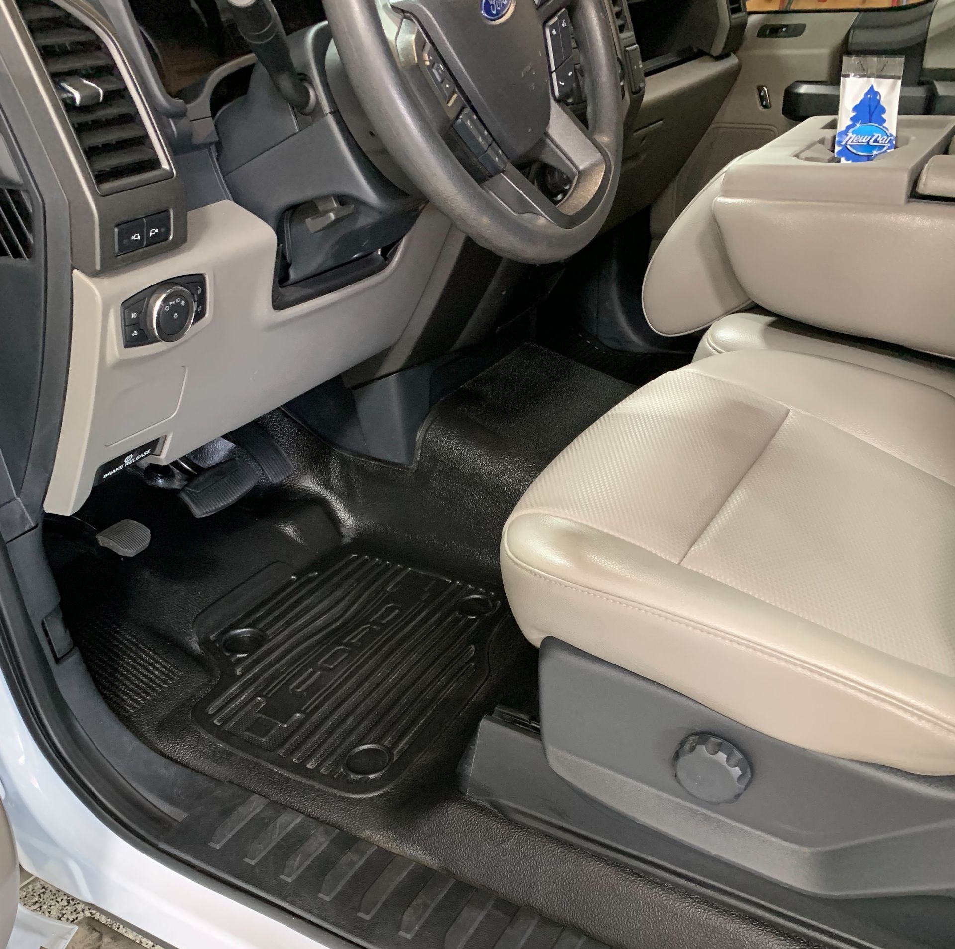The inside of a car with a steering wheel and seats