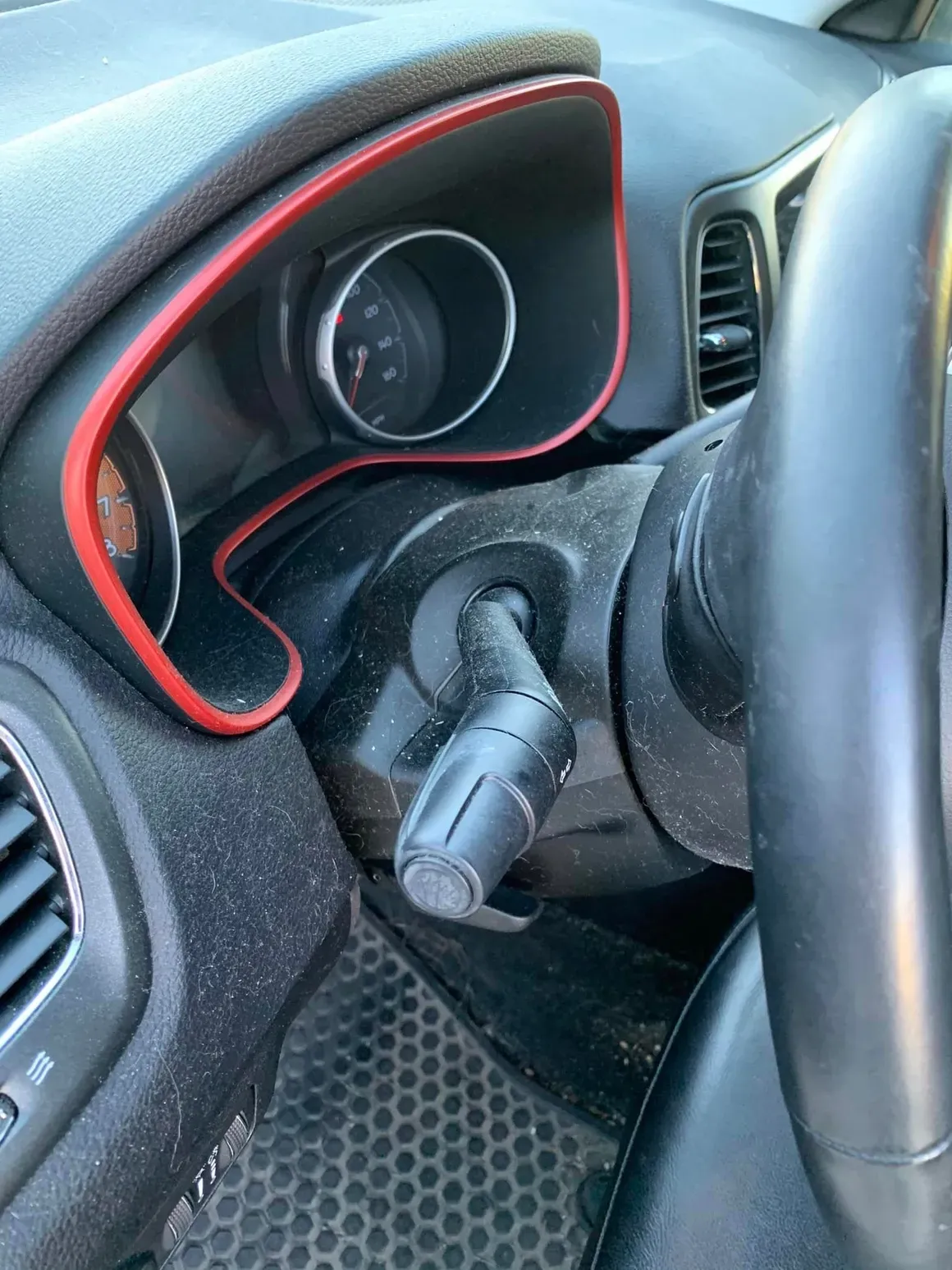 A close up of a car dashboard with a red trim