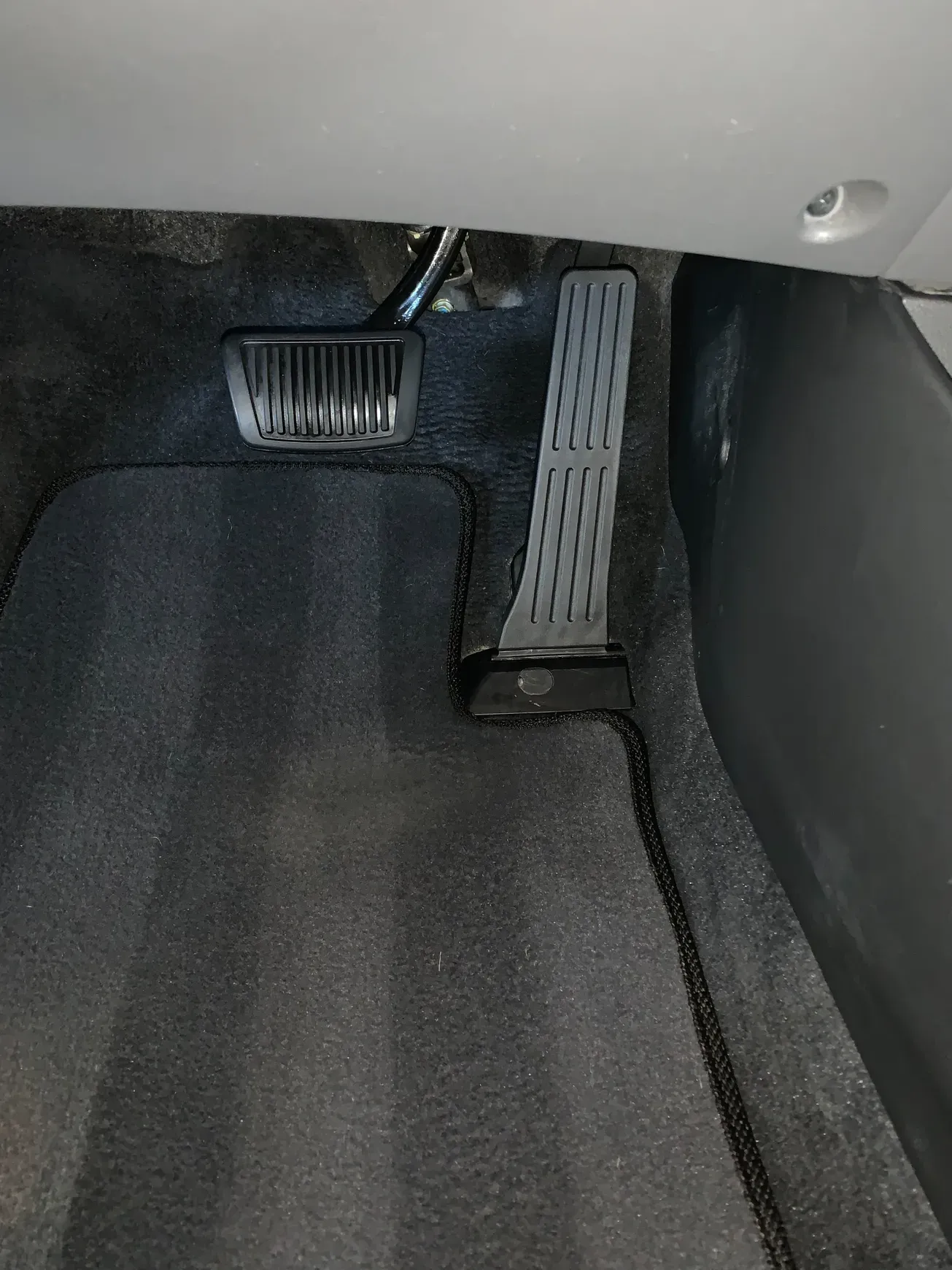 A close up of a car pedal in the trunk.