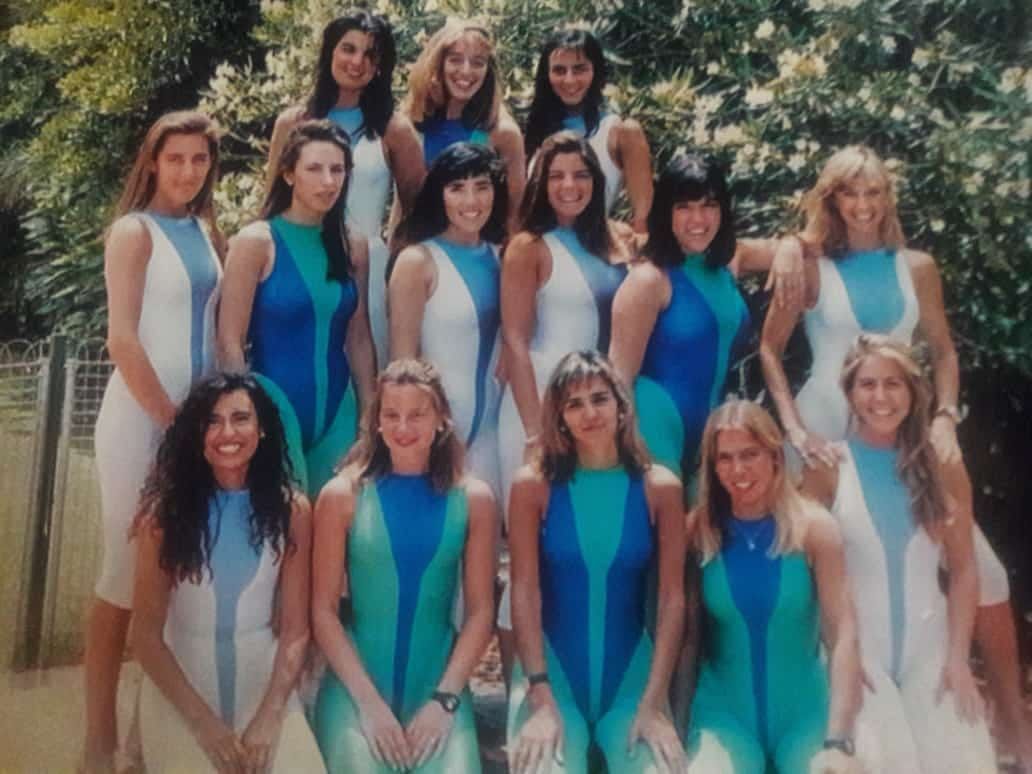 Mujeres con leotardos azules a juego posando al aire libre para una foto grupal