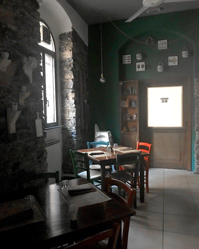 Un ristorante con tavoli e sedie e un ventilatore a soffitto