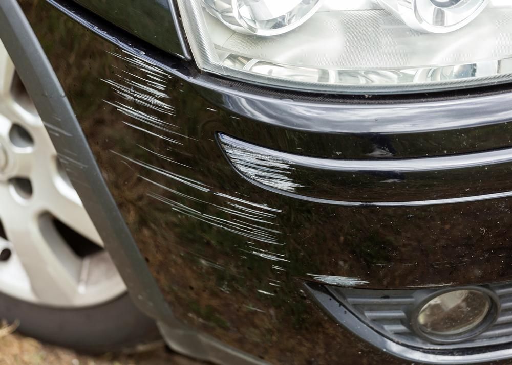 A Black Car With A Scratch On The Front Bumper — Platinum Paint & Panel Southport In Southport, QLD