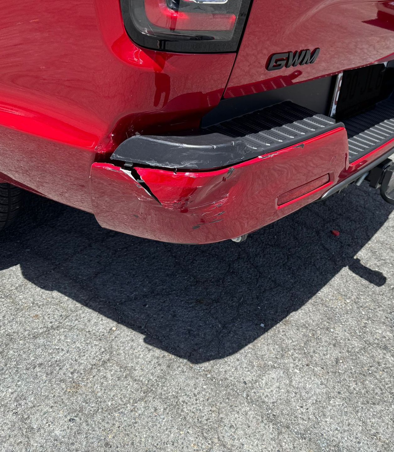 A Silver Car With A Damaged Bumper Is Parked In A Garage — Platinum Paint & Panel Southport In Southport, QLD