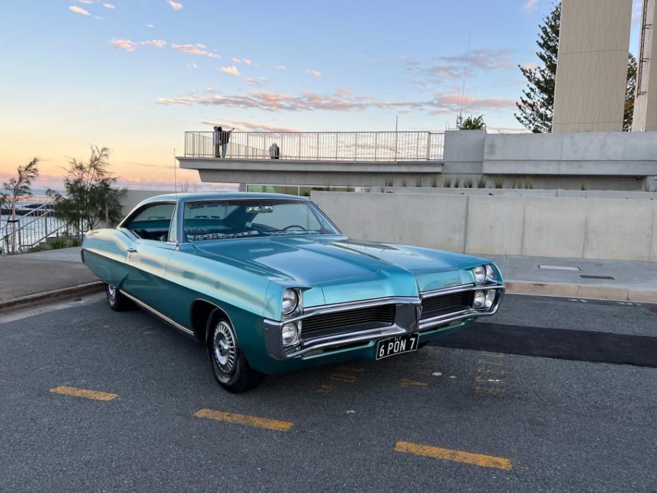 A Blue Car Is Parked On The Side Of The Road — Platinum Paint & Panel Southport In Southport, QLD
