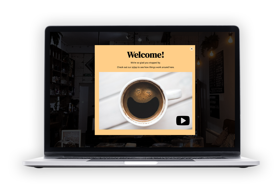 A laptop computer with a cup of coffee on the screen.
